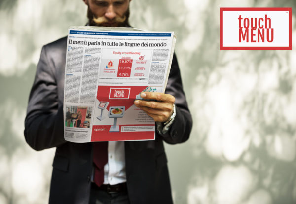 Businessman standing and reading newspaper